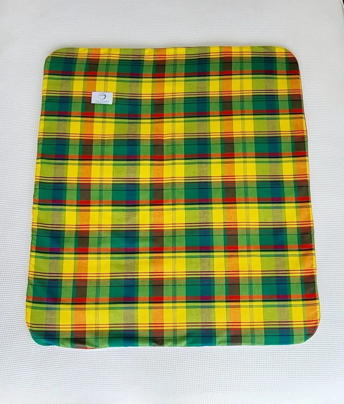 Vue complète de la couverture MADELYOS– face en tissu madras antillais aux tons vert, jaune et rouge confection artisanale Les Trésors d’Elikya. Couverture bébé douce, moelleuse et raffinée, idéale comme cadeau de naissance.