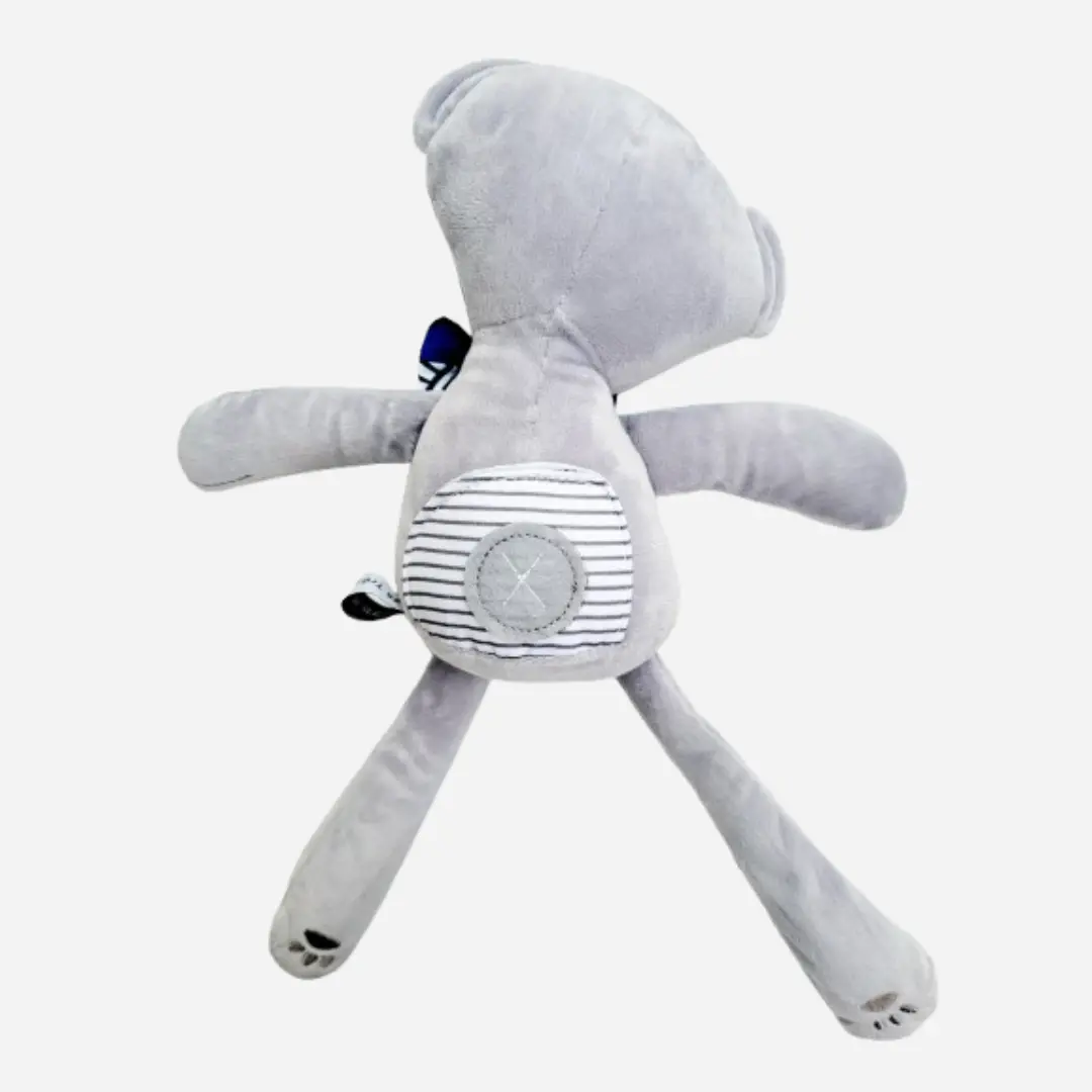 Vue de dos du doudou ours en peluche Teddy Wax FLORÉLYS, peluche artisanale en coton gris, douce et raffinée