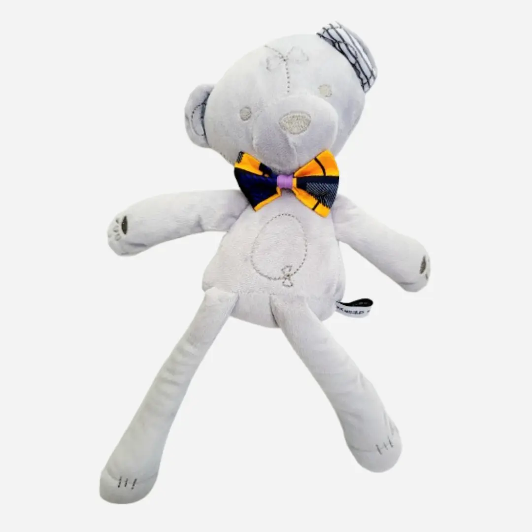 Doudou ours en peluche Teddy Wax TÉORÉ vu de face, peluche bébé douce et élégante avec nœud papillon Wax bleu et orange
